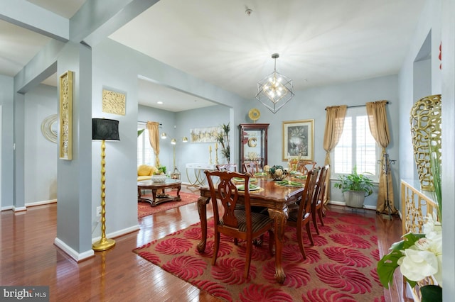 dining room featuring wood-type flooring and a notable chandelier