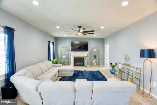 living room featuring ceiling fan, a healthy amount of sunlight, and light carpet