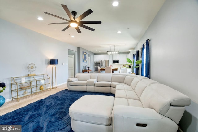 living room featuring carpet flooring and ceiling fan