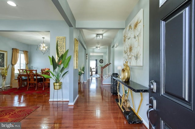 foyer featuring dark hardwood / wood-style flooring and an inviting chandelier