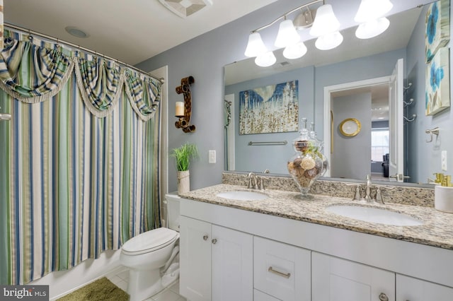 full bathroom with shower / bath combo with shower curtain, tile patterned flooring, vanity, and toilet