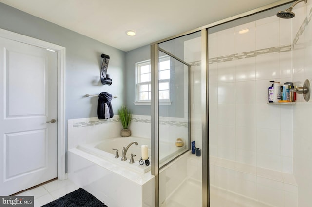 bathroom with shower with separate bathtub and tile patterned floors