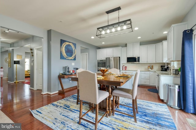 dining area with hardwood / wood-style floors