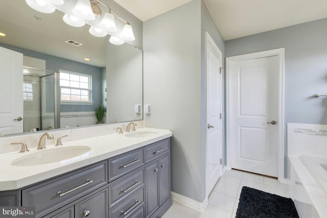 bathroom with tile patterned floors, vanity, and independent shower and bath