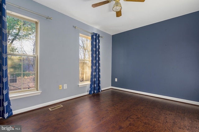 empty room featuring dark hardwood / wood-style floors and ceiling fan