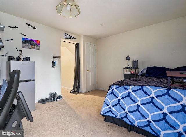 bedroom featuring light carpet and stainless steel refrigerator