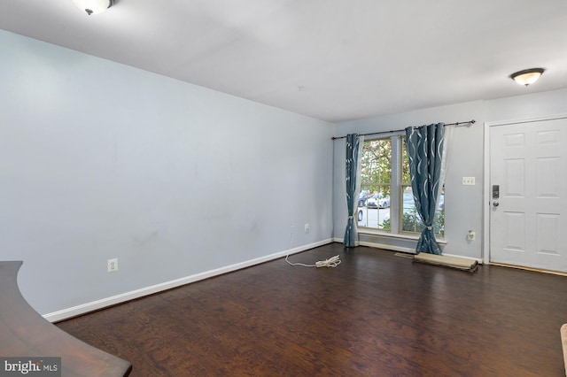 spare room with dark hardwood / wood-style floors