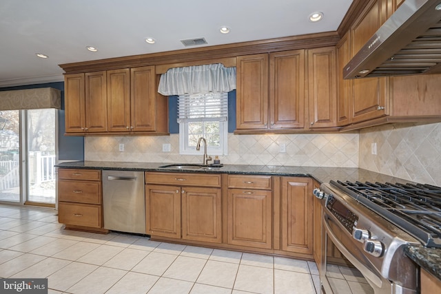 kitchen with backsplash, dark stone counters, ventilation hood, stainless steel appliances, and sink