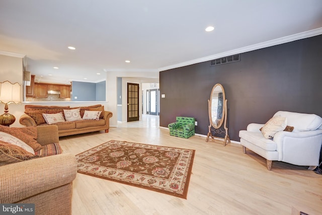 living room with light hardwood / wood-style flooring and crown molding