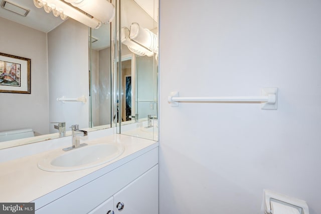 bathroom featuring vanity and toilet