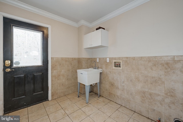 laundry room featuring washer hookup, light tile patterned flooring, crown molding, and tile walls