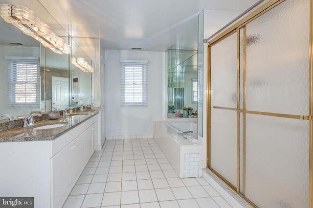 bathroom featuring tile patterned floors, plenty of natural light, vanity, and independent shower and bath