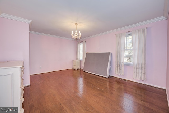 unfurnished room with dark hardwood / wood-style flooring, crown molding, and a notable chandelier