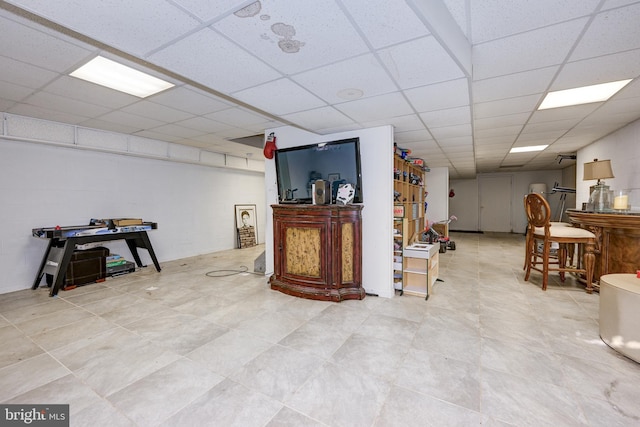 basement featuring a drop ceiling