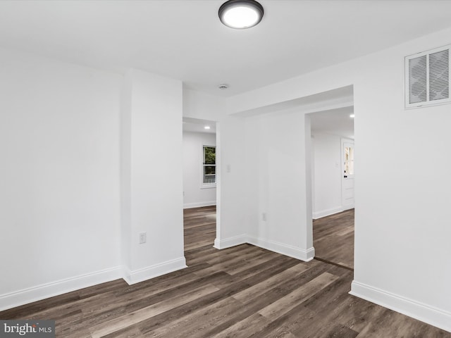 empty room with dark wood-type flooring