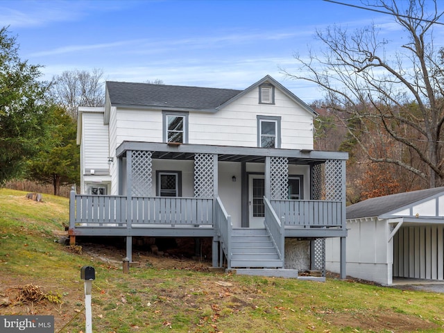 rear view of property with a lawn and a porch