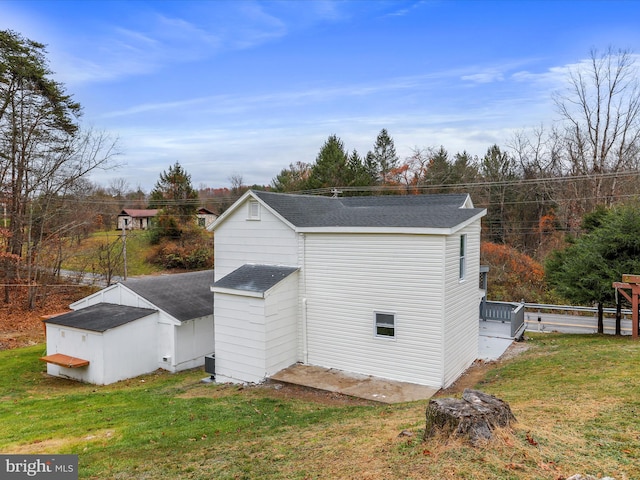 view of side of home with a lawn