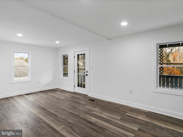 spare room featuring dark wood-type flooring