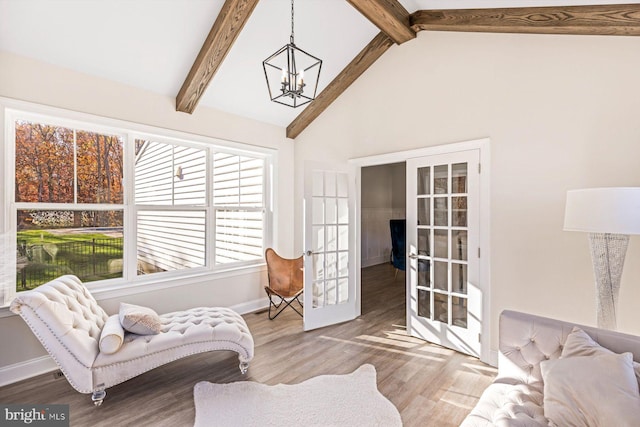 living area with french doors, wood-type flooring, beam ceiling, high vaulted ceiling, and an inviting chandelier