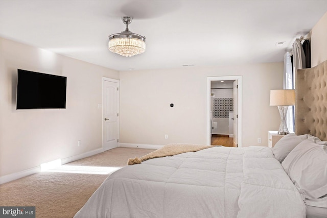 carpeted bedroom with ensuite bath