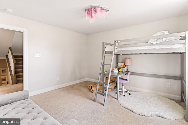 carpeted bedroom featuring baseboards