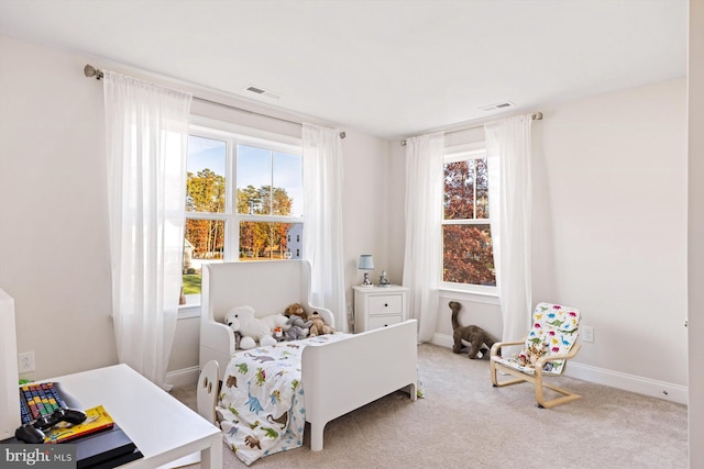 carpeted bedroom featuring multiple windows