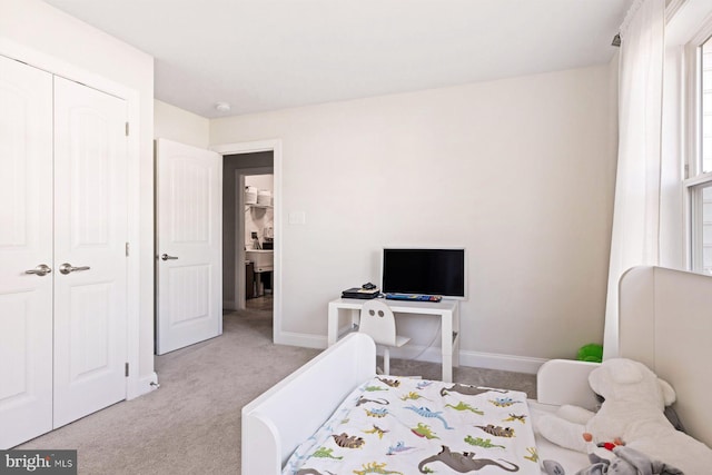 bedroom featuring a closet and light carpet