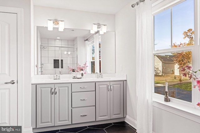 bathroom with plenty of natural light, vanity, tile patterned floors, and a shower with shower door