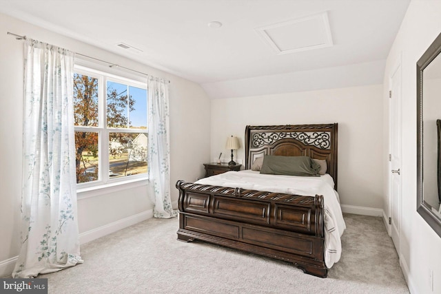 bedroom with light colored carpet and vaulted ceiling