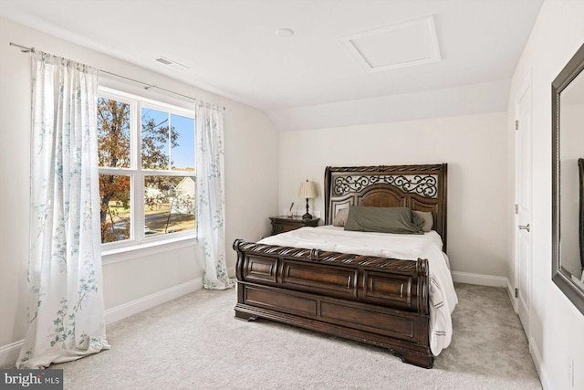bedroom with attic access, carpet flooring, and baseboards