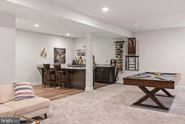 bar with pool table, light hardwood / wood-style flooring, sink, and dark brown cabinetry