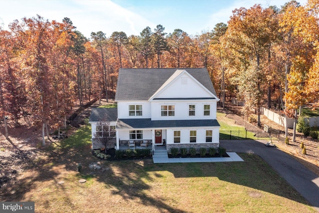 view of front of house with asphalt driveway and a shingled roof