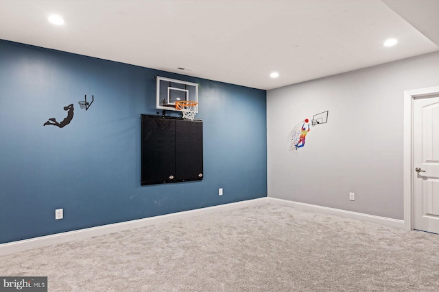 spare room featuring carpet, recessed lighting, and baseboards