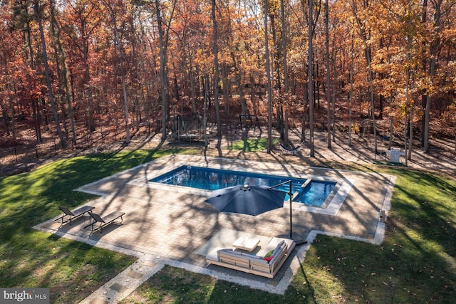 view of pool featuring a lawn and a patio area