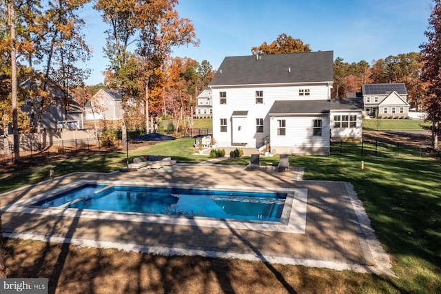 rear view of house featuring a patio and a yard