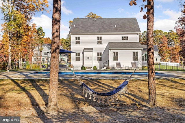 back of property featuring a covered pool