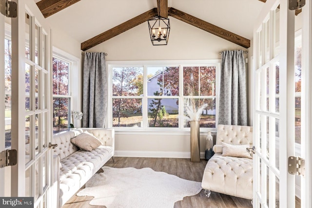 sunroom featuring french doors, vaulted ceiling with beams, and an inviting chandelier