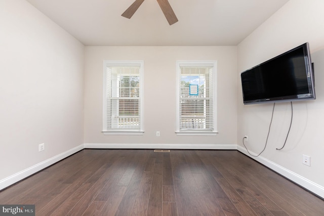 unfurnished room featuring dark hardwood / wood-style flooring and ceiling fan