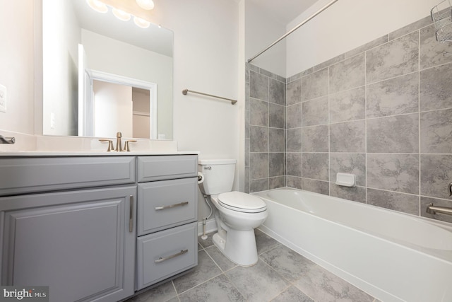 full bathroom featuring toilet, vanity, and tiled shower / bath