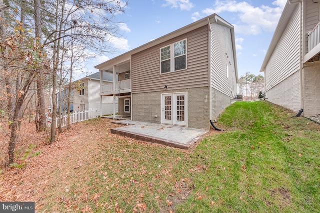 back of house featuring a yard and a patio