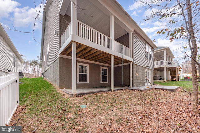 rear view of property with a lawn and a patio area