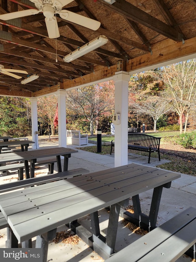 wooden terrace with a gazebo and ceiling fan