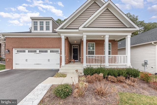 view of front of house featuring a porch and a garage