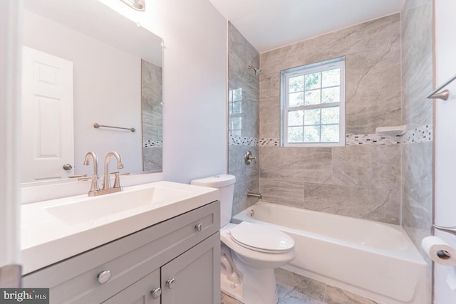 full bathroom with vanity, toilet, and tiled shower / bath