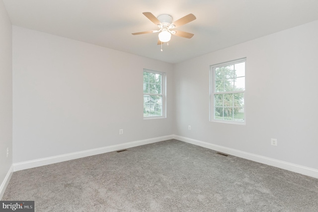 spare room with ceiling fan and carpet floors