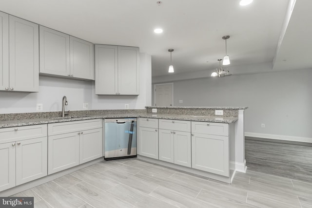 kitchen featuring pendant lighting, sink, stainless steel dishwasher, light stone countertops, and kitchen peninsula