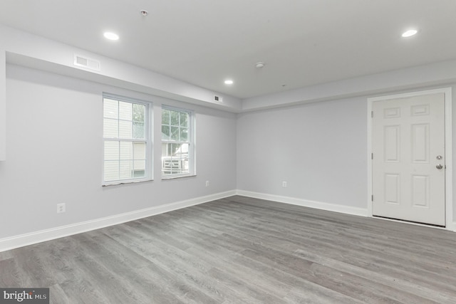 spare room featuring wood-type flooring