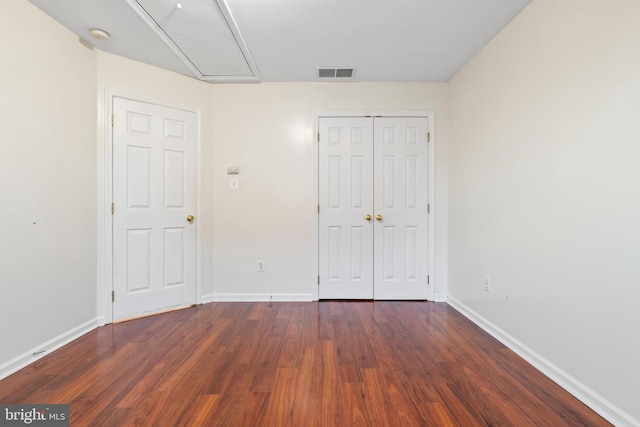 unfurnished bedroom featuring dark hardwood / wood-style flooring