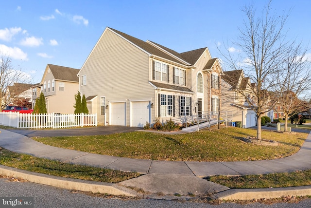 view of front of property with a garage and a front lawn