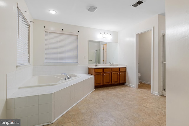 full bathroom with toilet, plus walk in shower, vanity, and tile patterned flooring